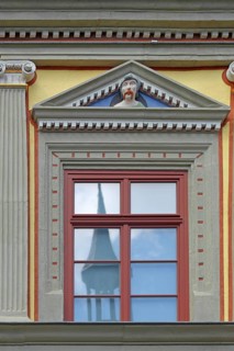 Window with decorations and grimace, face, head, grimace, envious head, detail, pilasters, fluting,