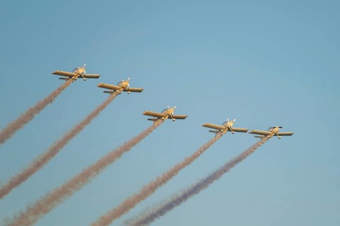 Stunt aerobatic planes performing stunts in blue sky with smoke trail. Concept of teamwork,