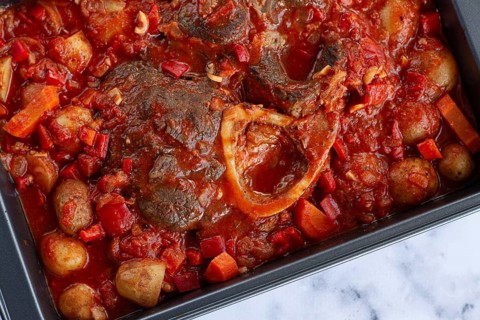 Ossobuco stew with vegetables, knuckle on the bone with new potatoes, in tomato sauce, homemade,