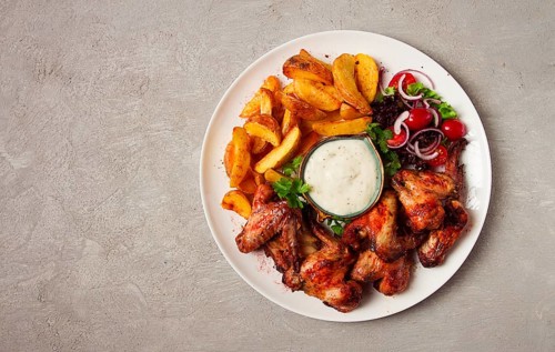 Fried chicken wings, with potatoes, and spices, homemade, fast food, no people