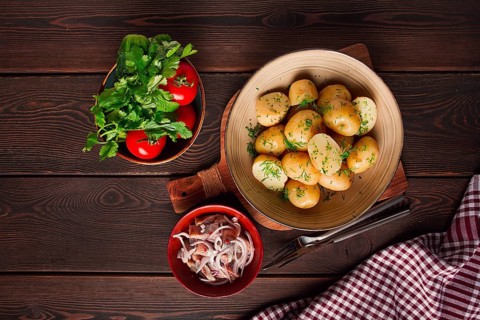 Fresh Cooked, new potatoes, with dill, on a wooden table, selective focus. close-up, toning, no