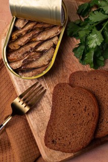 Preserves, sprats with black bread, top view, no people