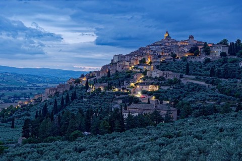 Trevi, illuminated at dusk, is a small Italian town in the province of Perugia in Umbria and a