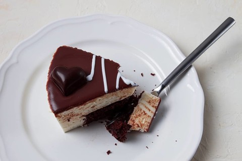 Slice of cake, bird's milk, chocolate sponge cake with souffle, sweet dessert, on a white plate,