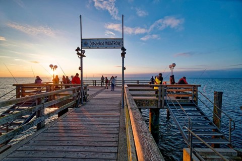Baltic Sea beach, Baltic Sea coast Anglers on the Wustrow pier, evening mood, Baltic seaside resort