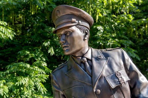 Bronze statue, monument to rock singer Elvis Presley, King of Rock 'n' Roll in uniform of the 3rd