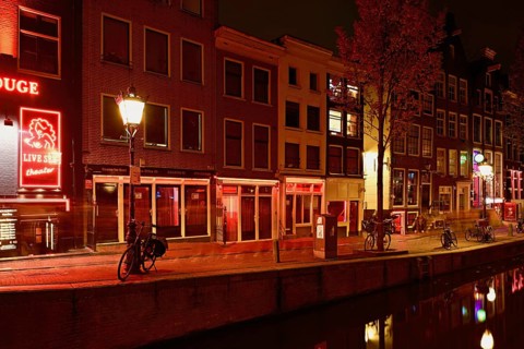 Night shot of the Oudezijds Achterburgwal in the red light district in Amsterdam, North Holland,