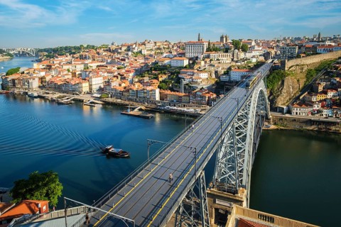 View of Porto city and Douro river and Dom Luis bridge I with metro tram from famous tourist