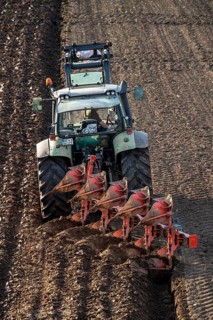 Farmer ploughing a field, tractor with plough, near Neuss, North Rhine-Westphalia, Germany, Europe
