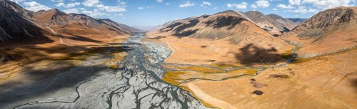Aerial view, Burkhan mountain valley with meandering river, barren dramatic mountain landscape,