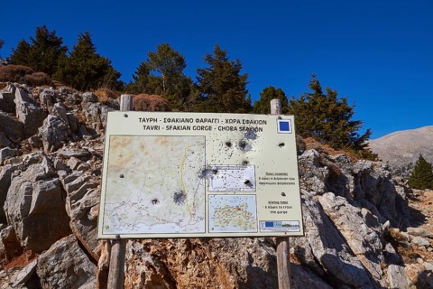 Niatos Plateau, information map on a signpost in a mountainous landscape by daylight, near Askifou,