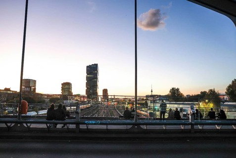 Chilling out at sunset on the Modersohn Bridge, view of railway tracks, trains and the 140 metre