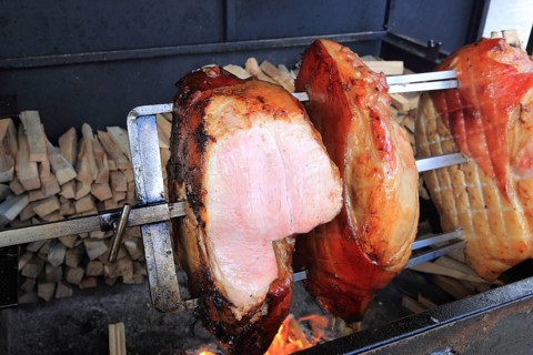 Pieces of pork are grilled on a spit over a wood fire, a speciality in Prague, Czech Republic,