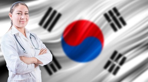Doctor with crossed arms on South Korean flag. Doctor with stethoscope on South Korean flag.