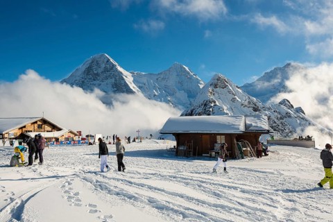 Wooden chalet and ski slope, with views of the Eiger, Mönch and Tschuggen, Grindelwald, Bernese