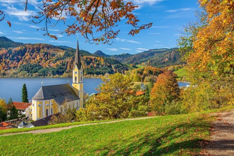 Panorama of the village and lake with the parish church of St. Sixtus in autumn, Schliersee,