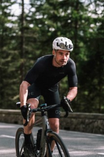 Road bike rider in spring in the Allgäu against the picturesque backdrop of the Alps, Bavaria,