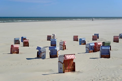 Colourful beach chairs on the beach, sand drifts, blue sky, North Sea, Juist, East Frisian Islands,