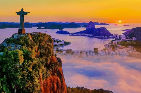 Corcovado 710m with Christ the Redeemer statue above Botafogo Bay with Sugar Loaf 396m at sunrise