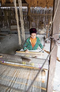 Vietnamese woman from the Hmong minority weaves linen fabric, Lung Tam linen weaving mill, Ha Giang