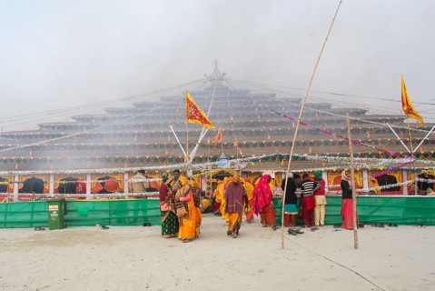 Devotees offer prayers at a makeshift Havan place on the eve of consecration ceremony of the Ram