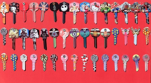 Display rows of picture Yale keys on red background, UK