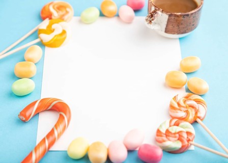 Composition with candies frame on blue pastel background. copy space, side view, template