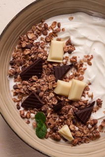 Yogurt with chocolate muesli, breakfast, close-up, fork on top, no people