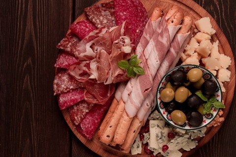 Appetizer, assortment, set, sausage, and cheese, on a wooden board, top view, no people