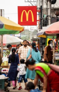 People walks by a McDonald's sign on October 26, 2024 in Guwahati, India. McDonald's recent food