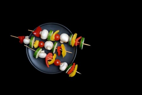 Colourful vegetable skewers on a plate, barbecue skewers