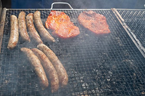 Grilled sausages and pork steak on the barbecue, Kirchweih in Franconia, Bavaria, Germany, Europe