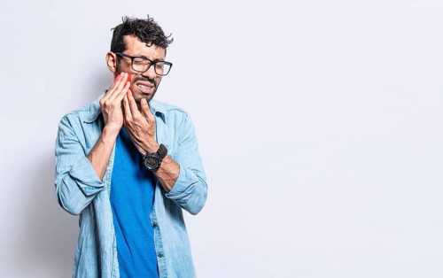 A man suffering from toothache isolated, People with toothache, person with hand on cheek with