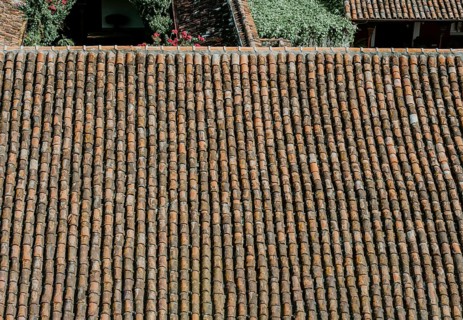 Details of a terracotta tile roof. Background of old clay tiles