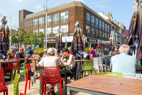 Customers sitting outside The Joseph Conrad Wetherspoon pub, Station Square, Lowestoft, Suffolk,