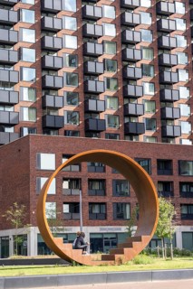 Walk-in steel sculpture on Maashaven Noordzijde Street, new high-rise residential buildings in the