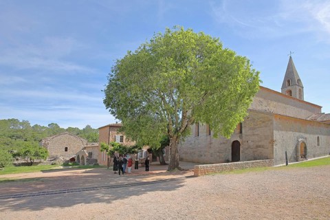Romanesque abbey Le Thoronet and group of people, tourists, monastery complex, Cistercian abbey,