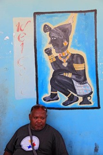 South Ethiopia, in Dimeka, local man sitting in front of a painting in a cafe, Ethiopia, Africa