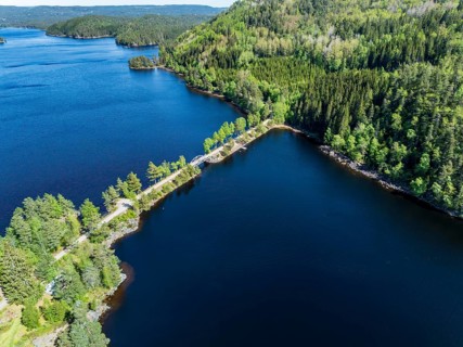 Bridge connecting island Kjeoeya with the mainland, Kilefjorden lake, Setesdal valley, Norway,