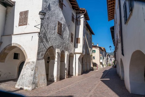 The town of Neumarkt, in the Adige Valley, in South Tyrol, arcades in the old town centre, in front