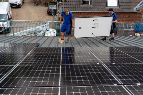 Installation of solar modules on the roof of a barn on a farm, over 240 photovoltaic modules are