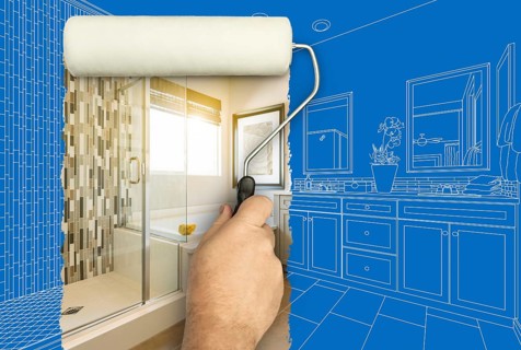Before and after of man painting roller to reveal newly remodeled master bathroom under blueprint