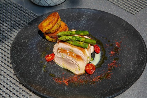 Tuna steak with green asparagus, fried potatoes served on a plate, main course, fish dish, Hotel