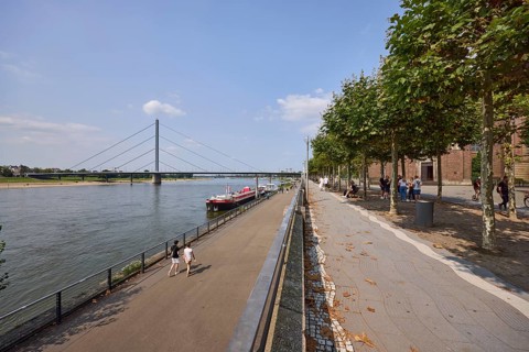 Riverside promenade with Rhine and Rhine knee bridge in Düsseldorf, state capital, independent