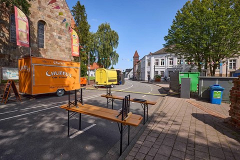 Castle square with snack carts and beer tent sets for the 900th anniversary celebration of the town