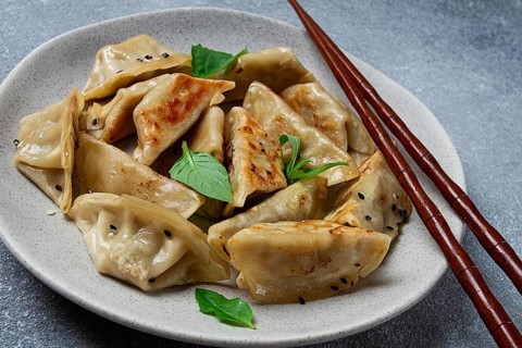 Japanese fried dumplings, gyoza, sesame seeds, top view, no people