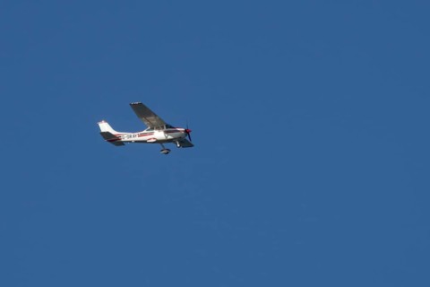 Cessna F182Q Skylane aircraft flying in a blue sky, England, United Kingdom, Europe