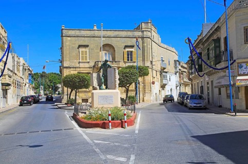 Historic streets in Tarxien area, near Valletta, Malta small square with war memorial sculpture