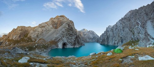 Wild camping, camping in the wilderness with a tent in front of mountain lake Kol Suu, Sary Beles