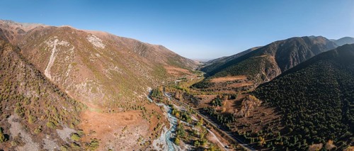 Aerial view, mountain stream Ala Archa flows through the Ala Archa valley, autumnal mountain